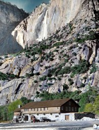 Hand-colored slide showing Yosemite Museum with Yosemite Falls in the background