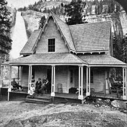 Building with people on deck and waterfall in background