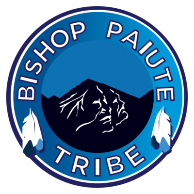 The graphic of a round blue seal with a mountain graphic in the middle and the words, "Bishop Paiute Tribe" around the border.