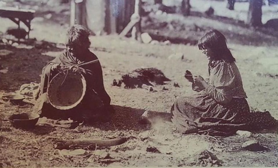 Two American Indian women making baskets in 1901