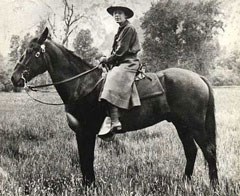 Female ranger riding horseback