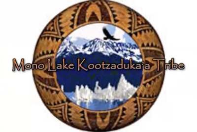 A graphic of a round seal with blue mountains and an eagle in the background surrounded by a woven basket-like border. The name, "Mono Lake Kootzaduka'a Tribe," is imposed across the center of the seal.