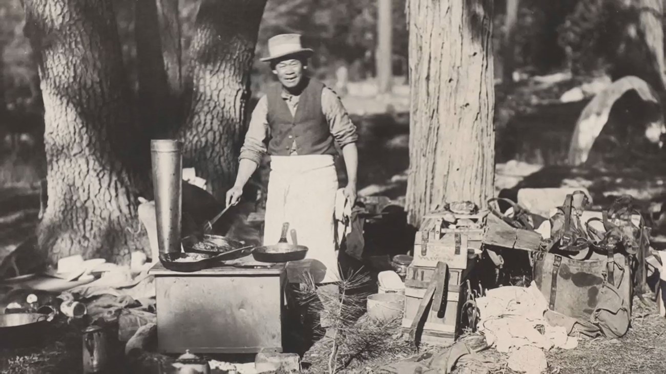 Tie Sing at smiling in his camp kitchen on a backcountry trip