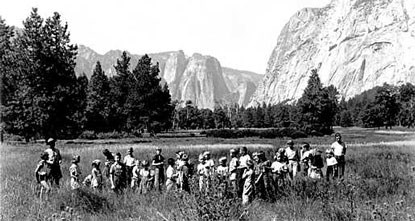 Ranger in Yosemite Valley field with children in historic photo