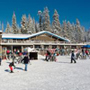 Visitors playing in the snow in front of the Badger Pass Lodge