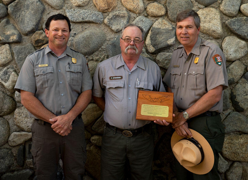 2018 Barry Hance Memorial Award: Karl Standen III with Gene Smith and Michael Reynolds The rangers standing, with person in middle showing an award