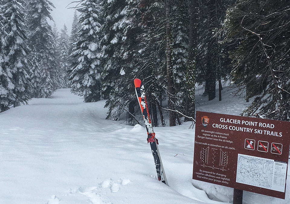 Glacier Point Road Cross Country Ski Sign with snow covered road and a pair of skis