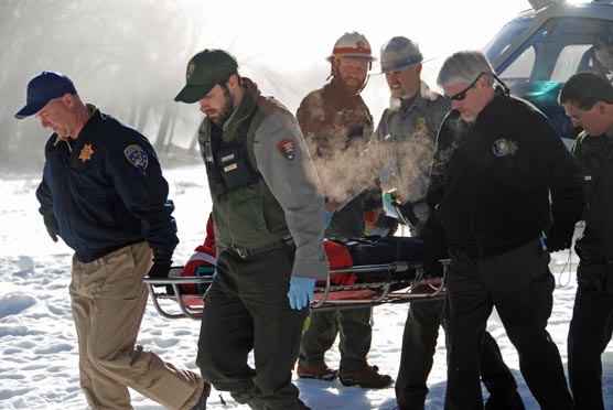 Rangers carrying patient in a litter