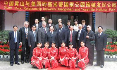 Chinese and American officials pose before banner