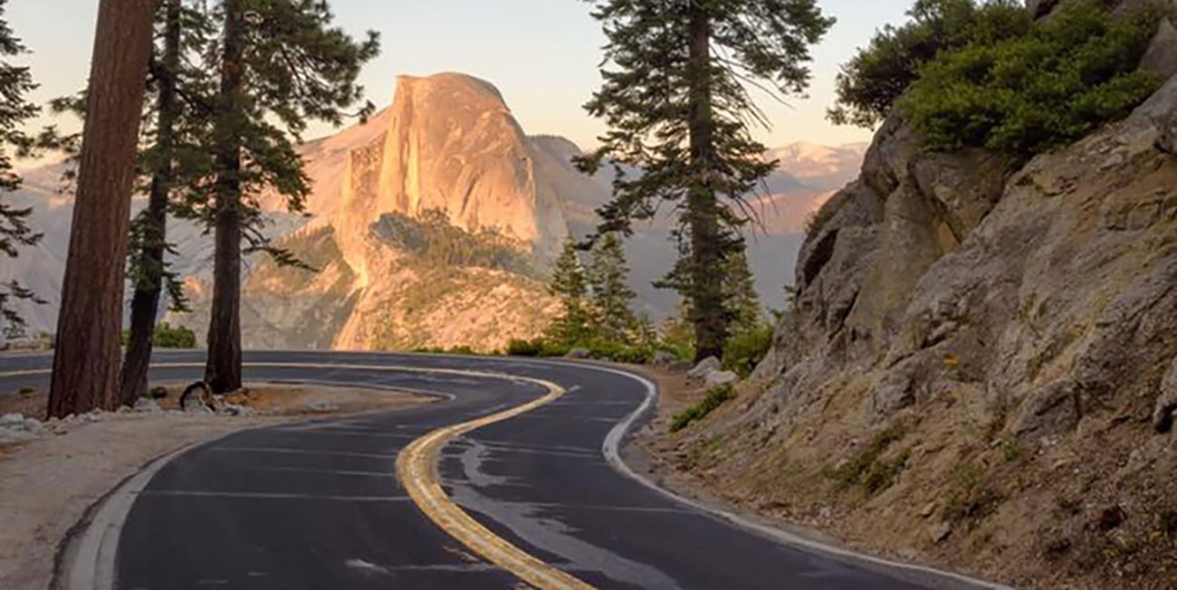 Sharp curves of Glacier Point Road with Half Dome in background