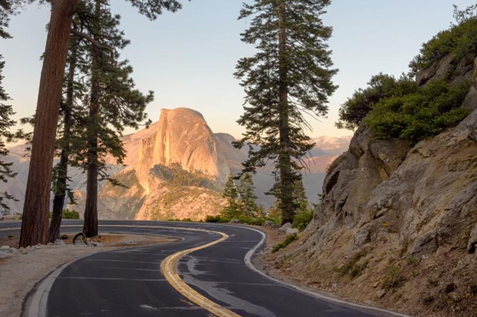 Sharp curves of Glacier Point Road with Half Dome in background