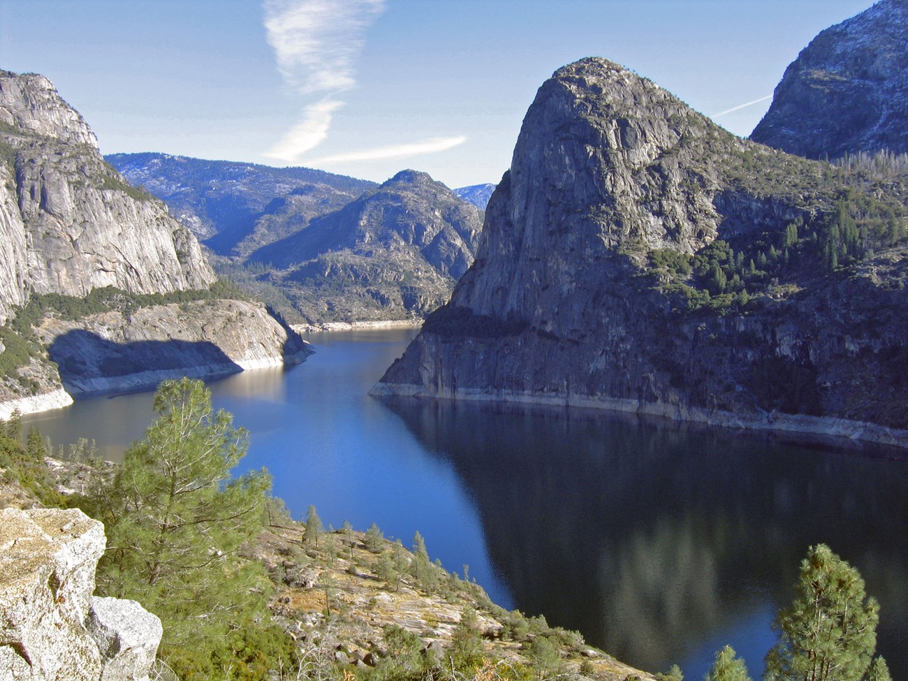 Granite cliffs surrounding a large reservoir.