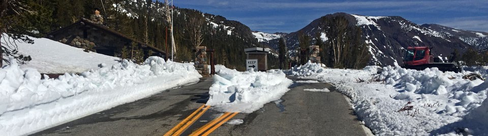 Snowy Tioga Pass Entrance with road cleared of snow Snowy Tioga Pass Entrance with road cleared of snow