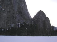 Lower and Middle Cathedral Rock loom over snow covered meadow