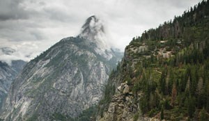 Half Dome disappears into the clouds.