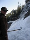 Ranger standing next to steep avalanche chute