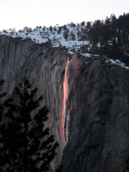 Glowing waterfall falling over side of El Capitan