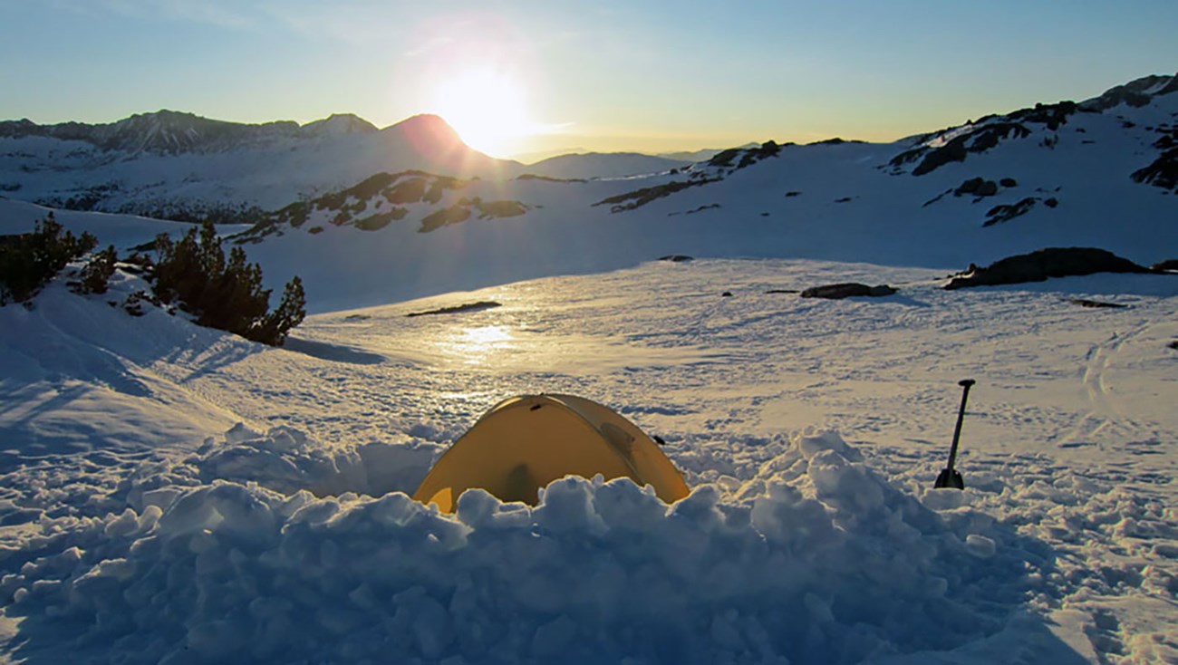 Sunrise over Donahue Pass in March 2013 with tent in snow