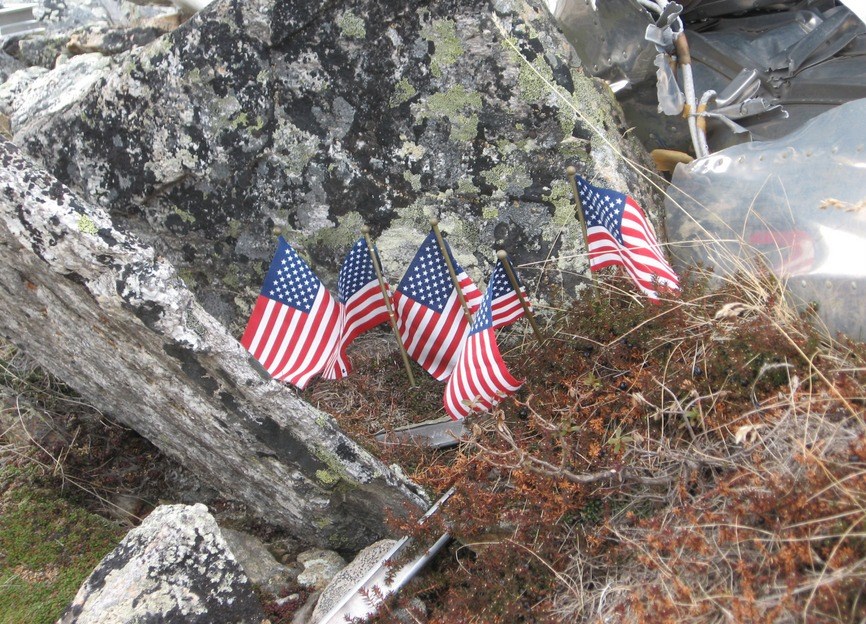 Flags left to honor the fallen at B-24 crash site. Flags left to honor the fallen at B-24 crash site.