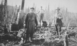 Placer miners in the 1930s using a small steam boiler and drift mining techniques on the Charley River.