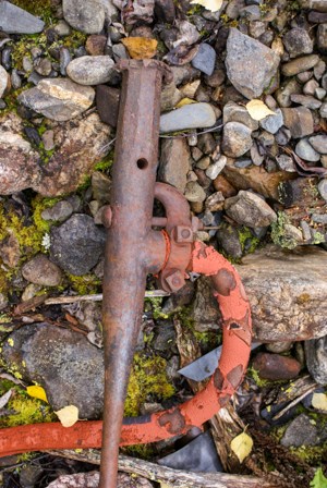 A steam point and hose lying on rocks