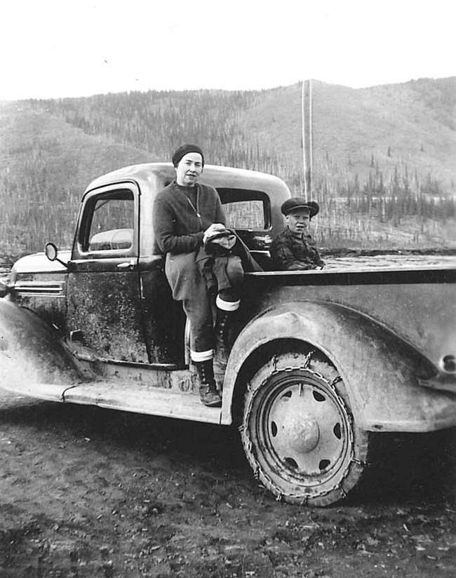 Mildred and Al Hendricks Jr sitting on a Dodge pickup truck