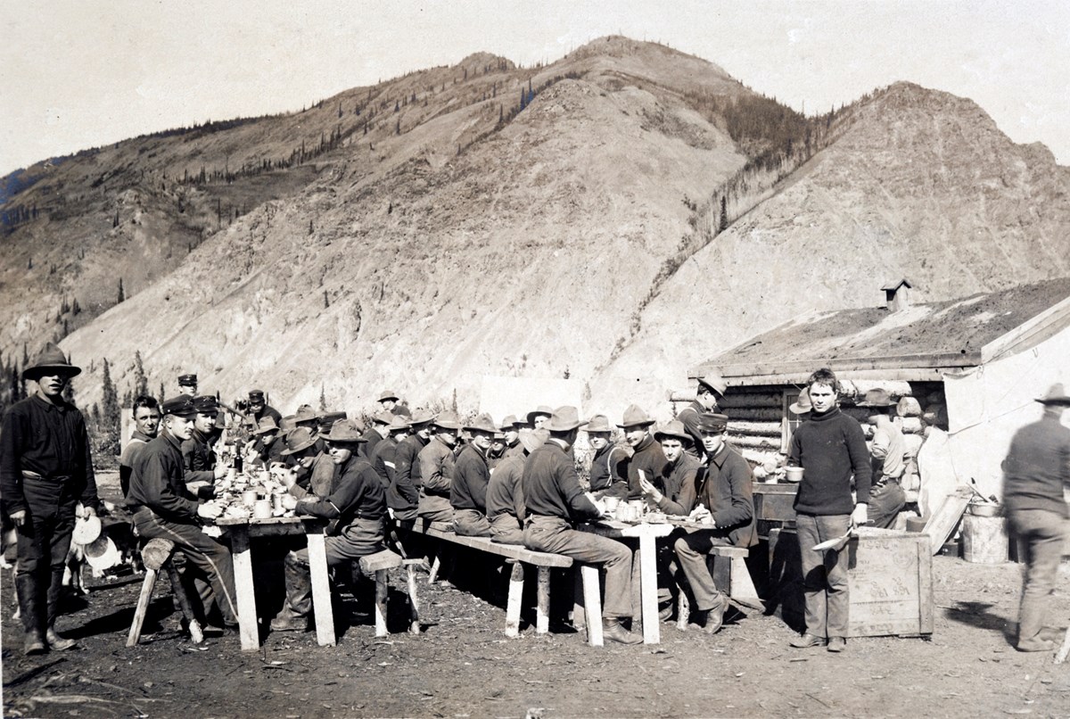 U.S. Army soldiers lunching during the construction of Ft. Egbert at Eagle City, 1899