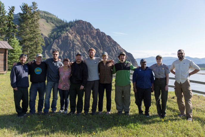 Student Conservation Association workers & NPS Fire staff in front of Eagle Bluff along the Yukon River in Eagle, Alaska