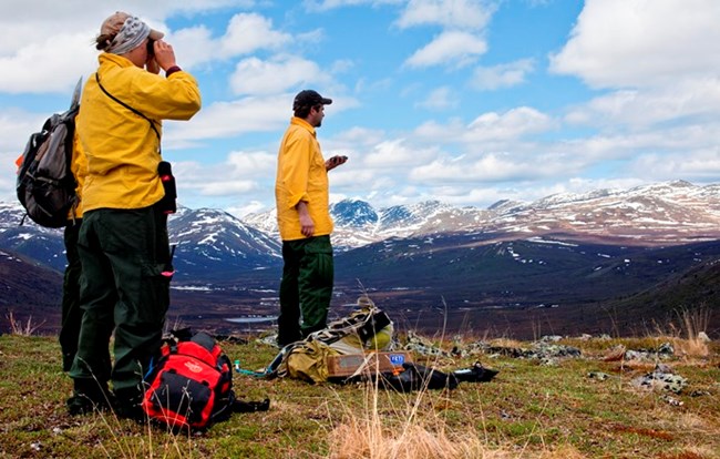 Archaeologists surveying in the mountains Archaeologists surveying in the mountains