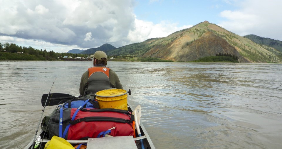 A canoeist on the Yukon River in front of Eagle