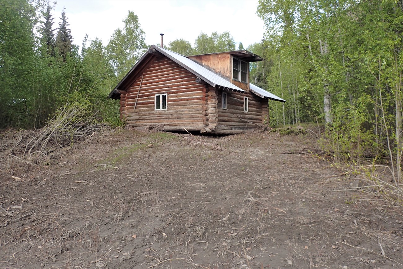 Floodwater damage at the Smith Public Use Cabin site, showing the cabin off its foundation, June 2, 2023.