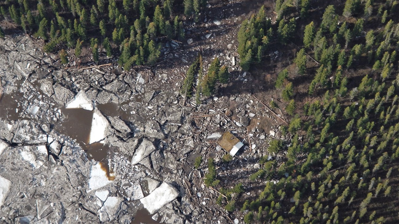 Aerial view of the Kandik Public Use Cabin, showing remaining river ice
