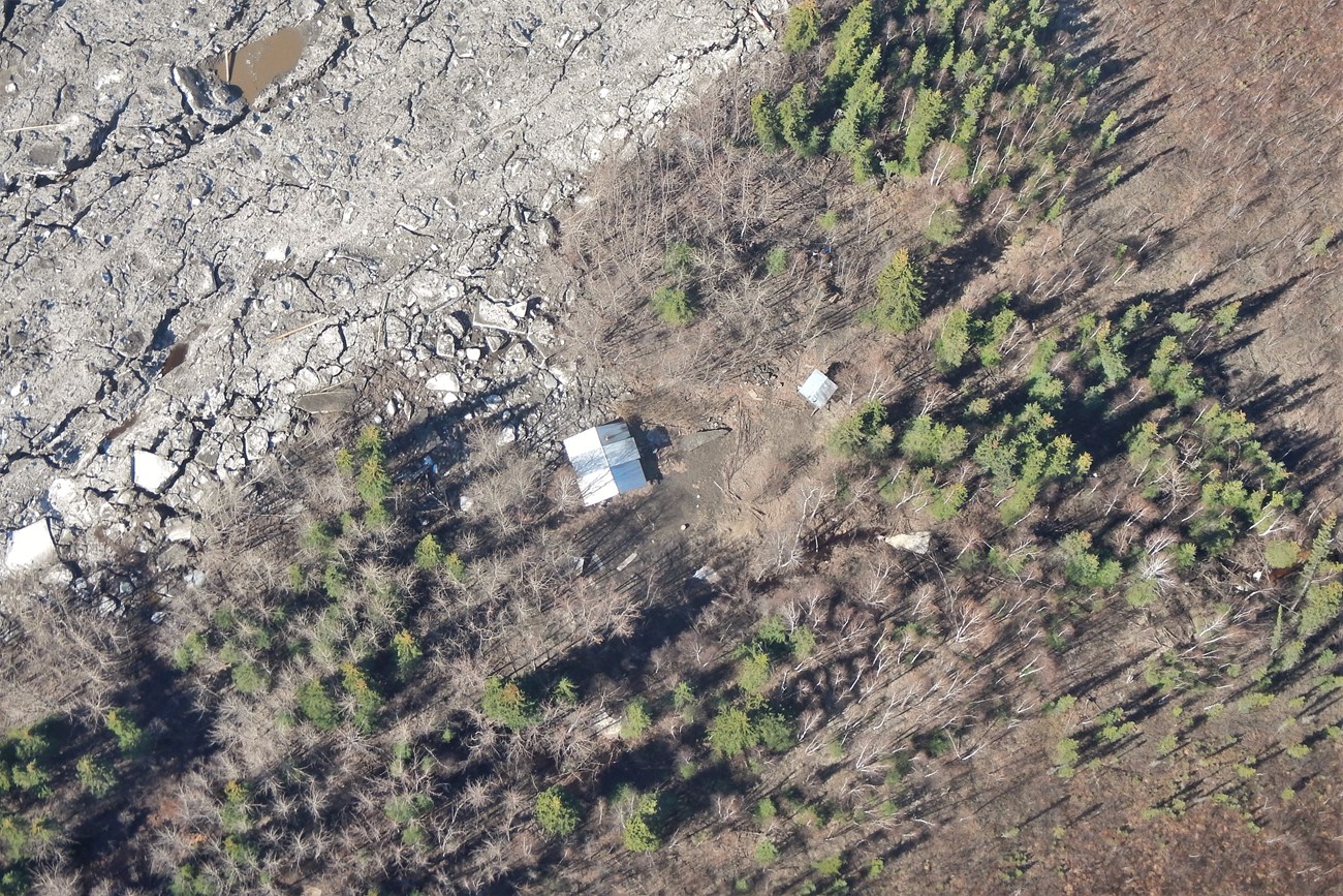Aerial view of the Smith Public Use Cabin, showing the cabin off its foundation and rotated, May 15, 2023.