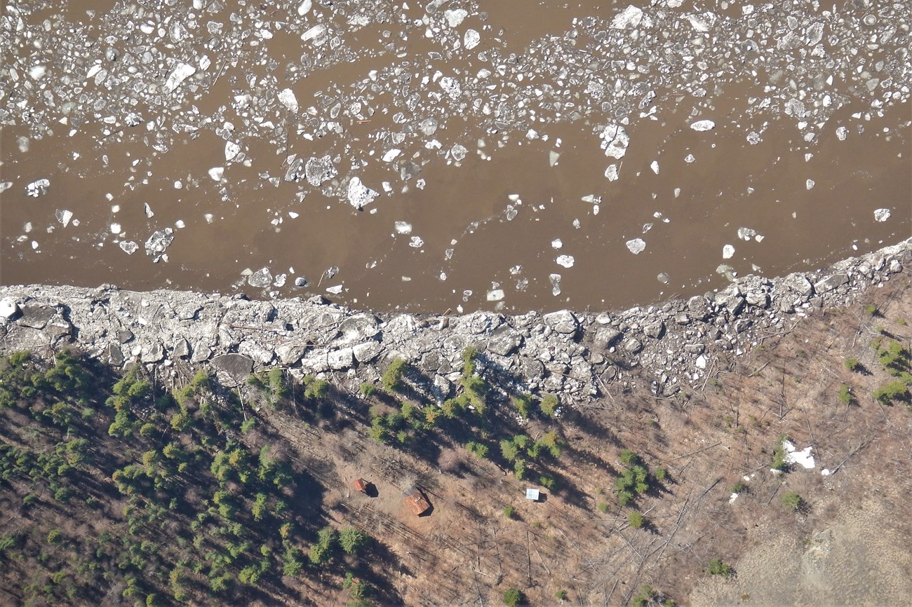 Aerial view of river ice remaining at the Nation Public Use Cabin shoreline.