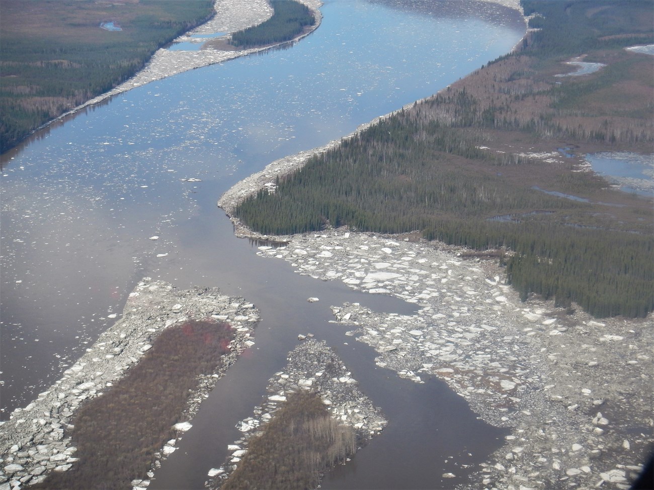 Aerial of the Kandik and Yukon Rivers confluence, showing high water and remaining river ice.