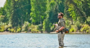 A man fly fishing on a river