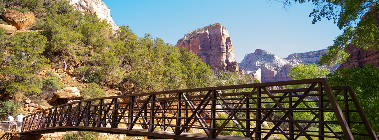 A tall sandstone peak stands above a large canyon.