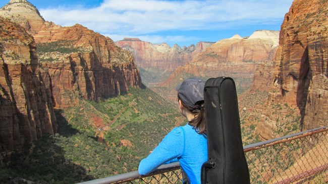 Musician Rachel Panitch looking out from the Canyon Overlook trail during her time in residence in the park, 2014.