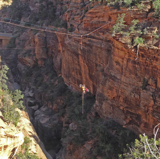 Ranger and patient hang in mid air by high line reeve system.