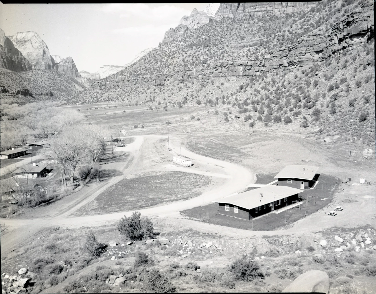 ZION 7832: After the end of the CCC program, the area where Camp NP-4 stood was leveled and turned into the Watchman residential area for National Park Service staff, pictured in this 1966 photo. ZION 7832: After the end of the CCC program, the area where Camp NP-4 stood was leveled and turned into the Watchman residential area for National Park Service staff, pictured in this 1966 photo.