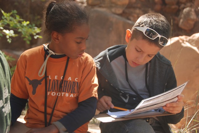 Two children looking at the park map