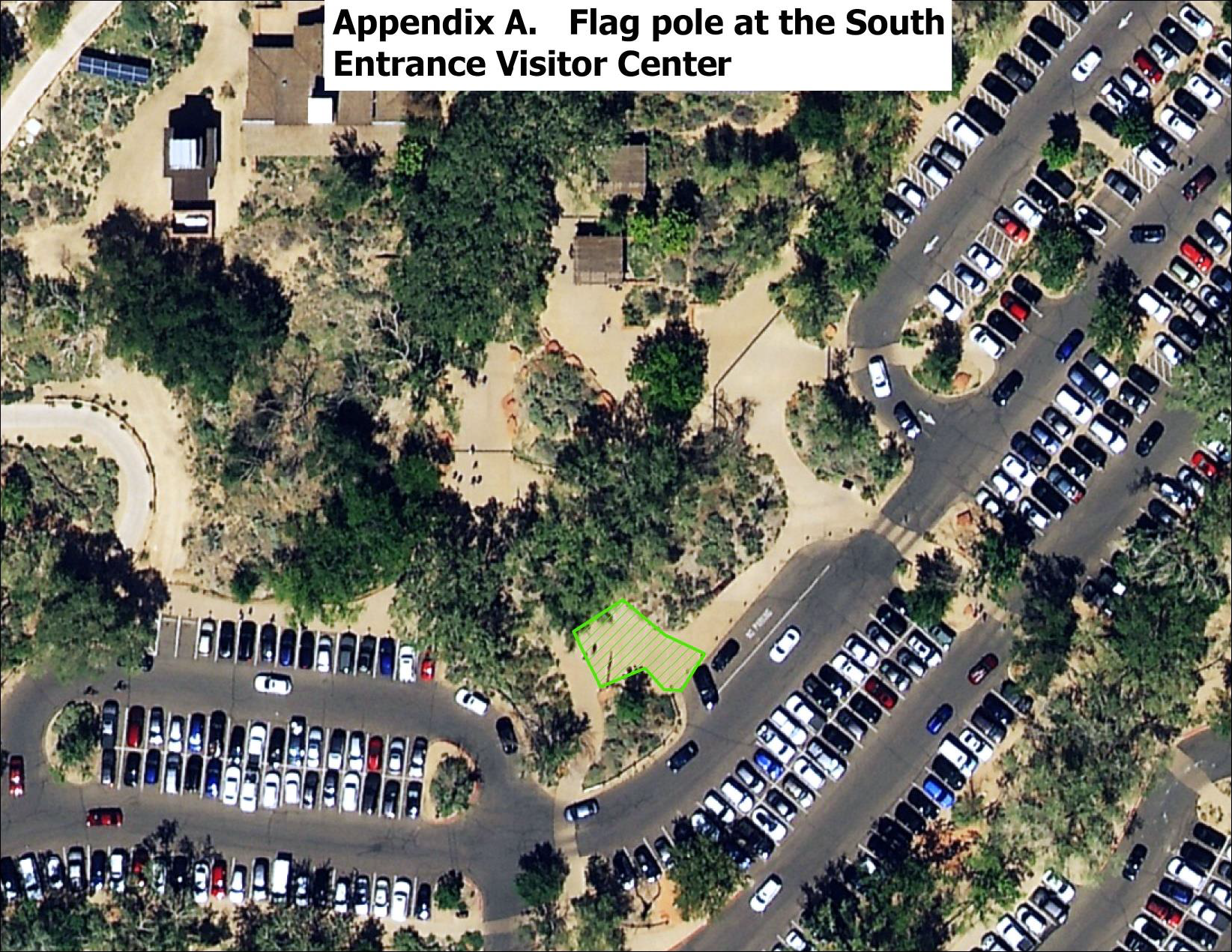 A satellite image showing the area just south of the Zion Canyon Visitor Center. Near the parking lot, a flag pole is visible. A small area adjacent to this flag pole is highlighted green, indicating a designated demonstration area.