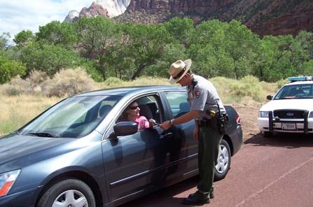 A park ranger pulls over a vehicle.