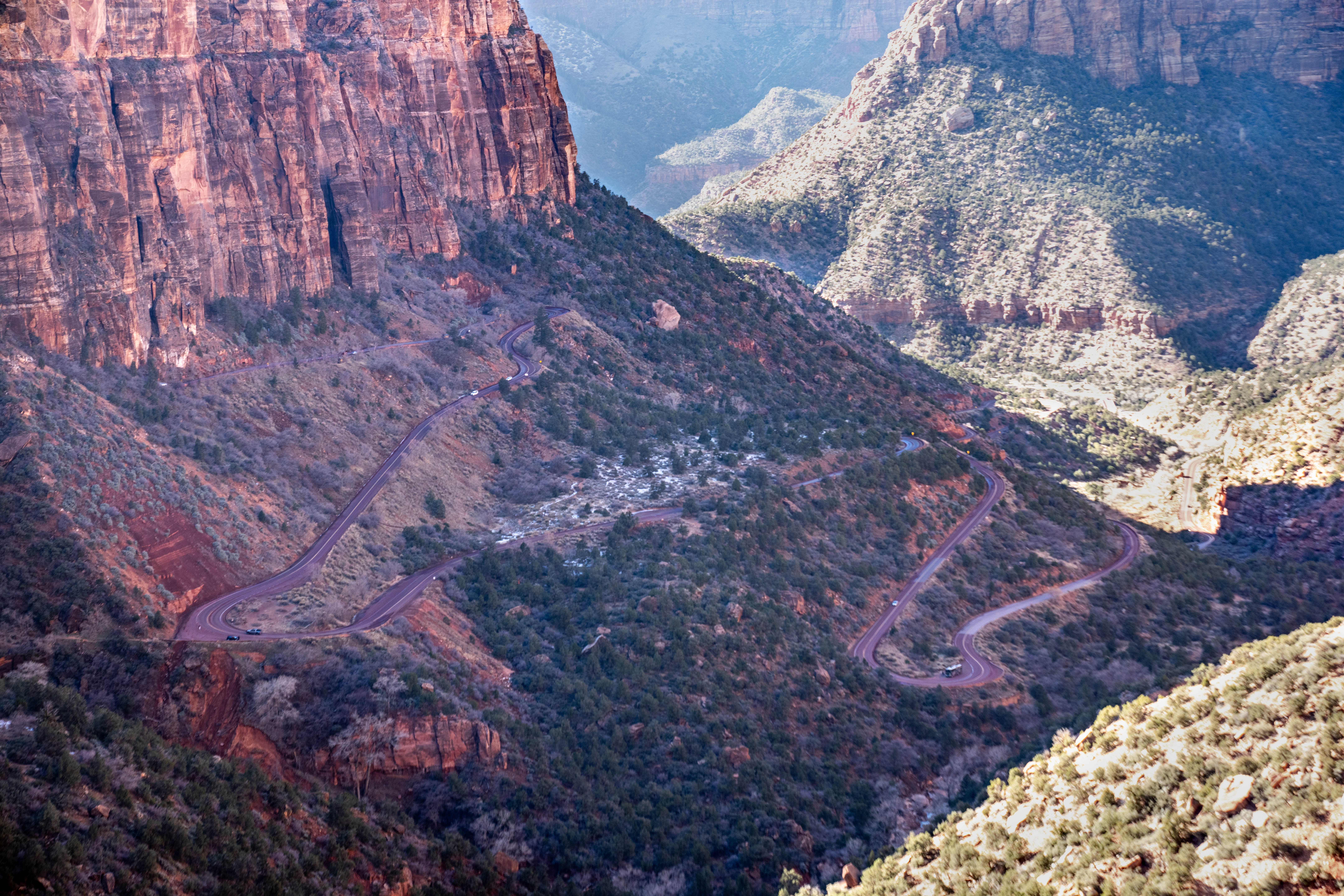 Canyon overlook Zion-Mt. Carmel HIghway A long winding road on the side of a mountain with sandstone cliffs in the background.