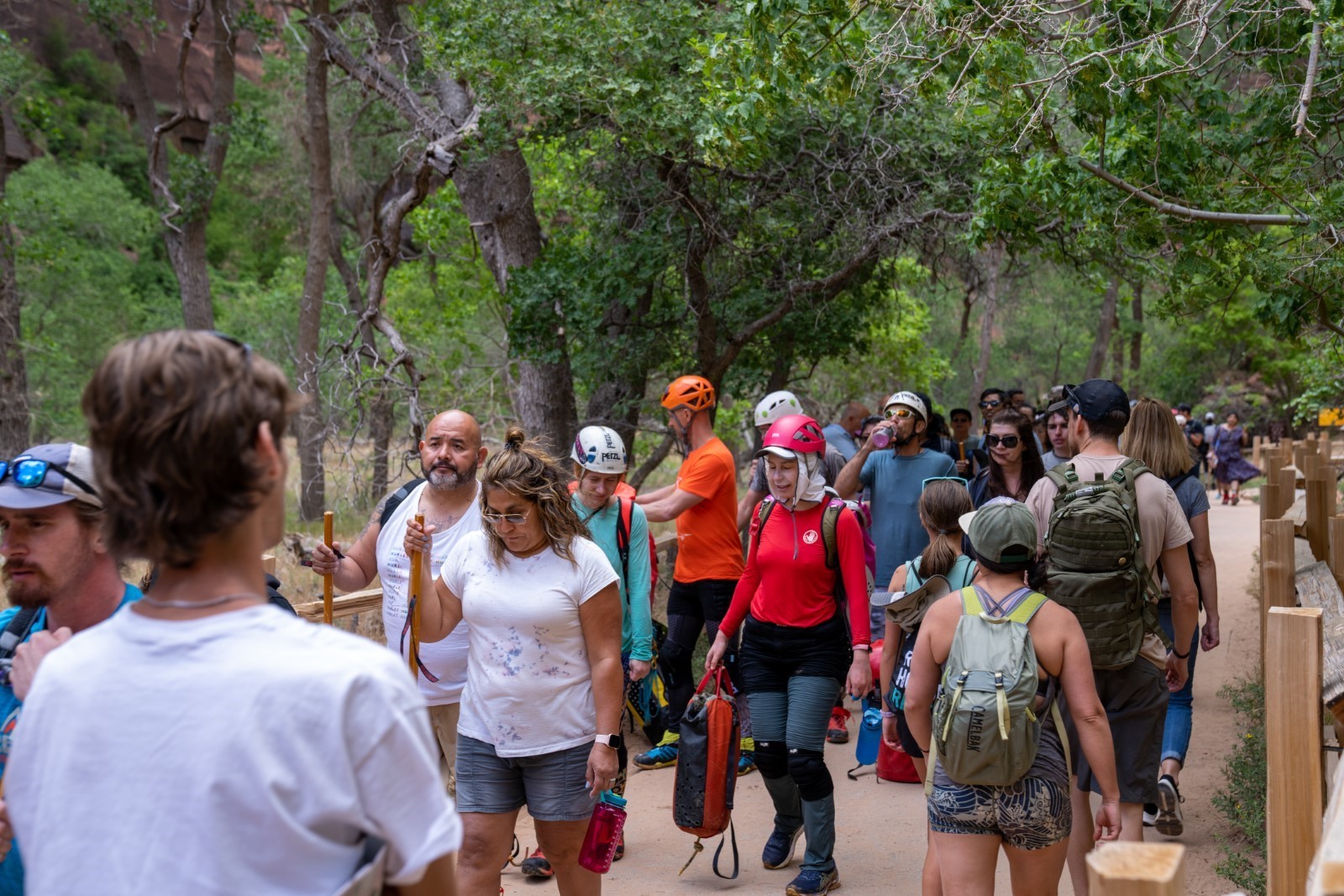 Memorial Day Busy Visitation 2022 A large group of people walking on a trail with green trees in the background