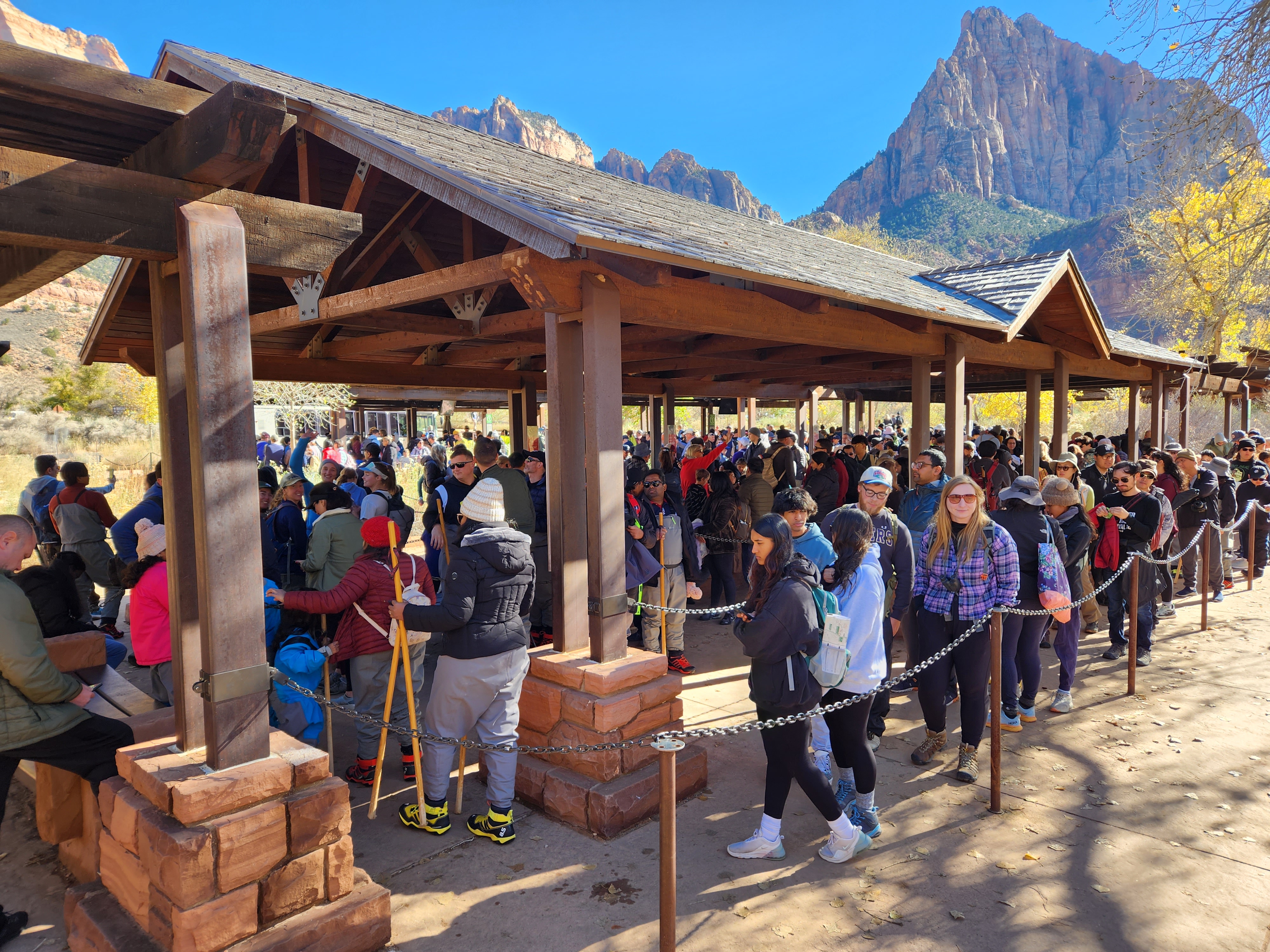 A long line of people waiting to board the Zion shuttle bus