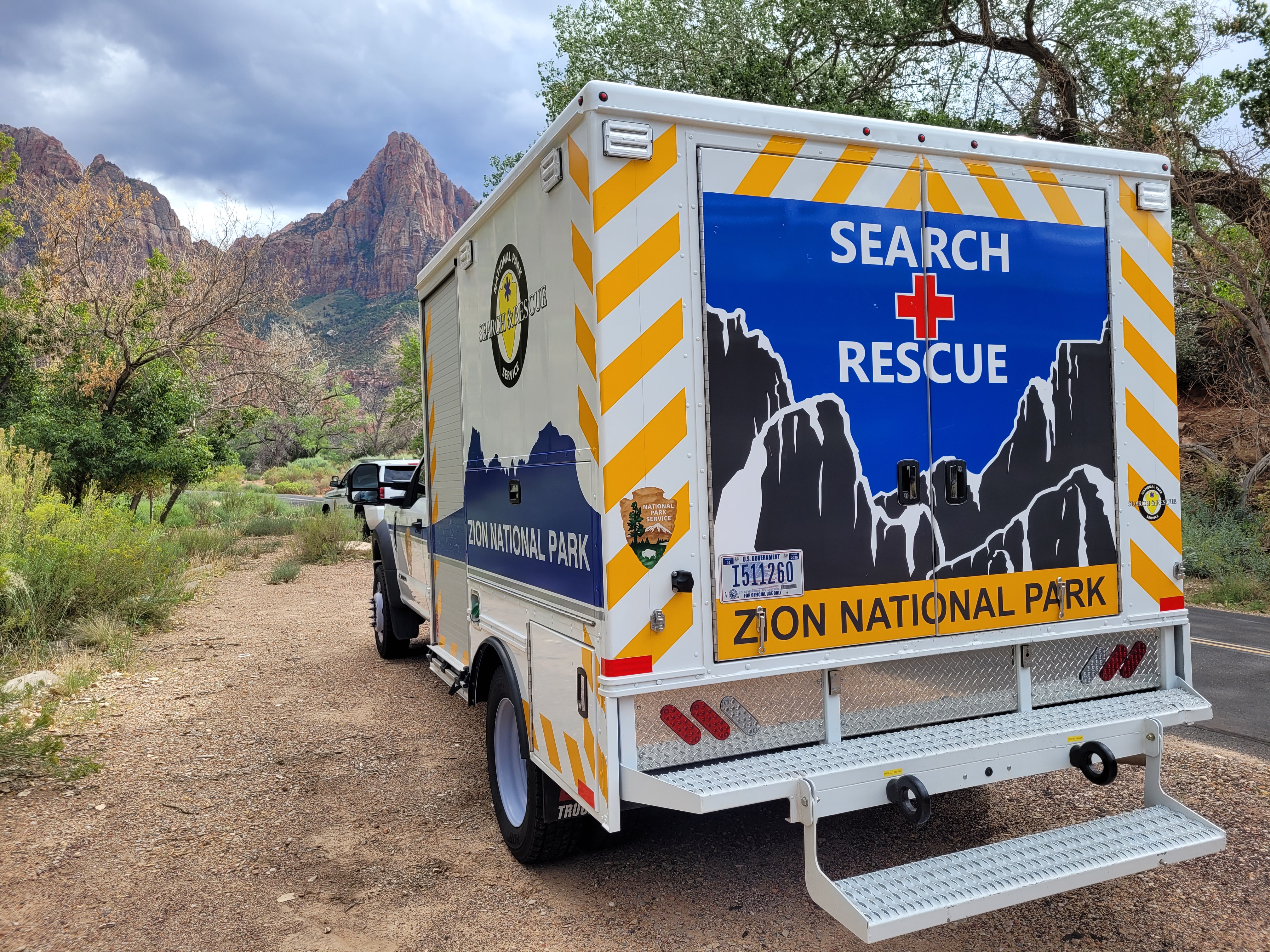 A truck with red rock in the background. The truck is labeled Zion Search and Rescue.