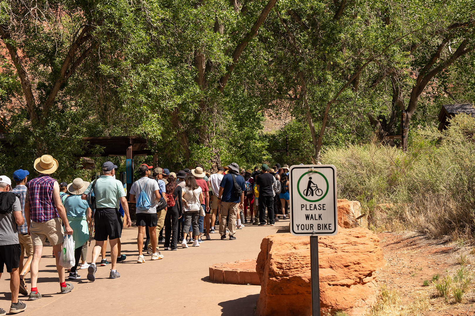 Visitor Center Shuttle Line A long line of people in a courtyard