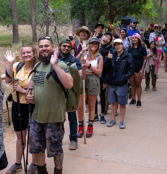 Visitors enjoy Zion in line for a shuttle at the Temple of Sinawava during Memorial Day Weekend 2022. People in line at Zion National Park