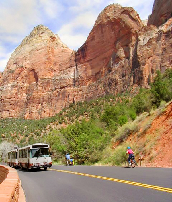 Zion Shuttle with bikes nearby. Zion Canyon Scenic Drive with shuttle and bicycles on road.